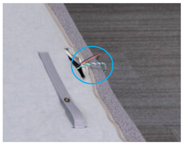 Wires sticking out a mattress cover.