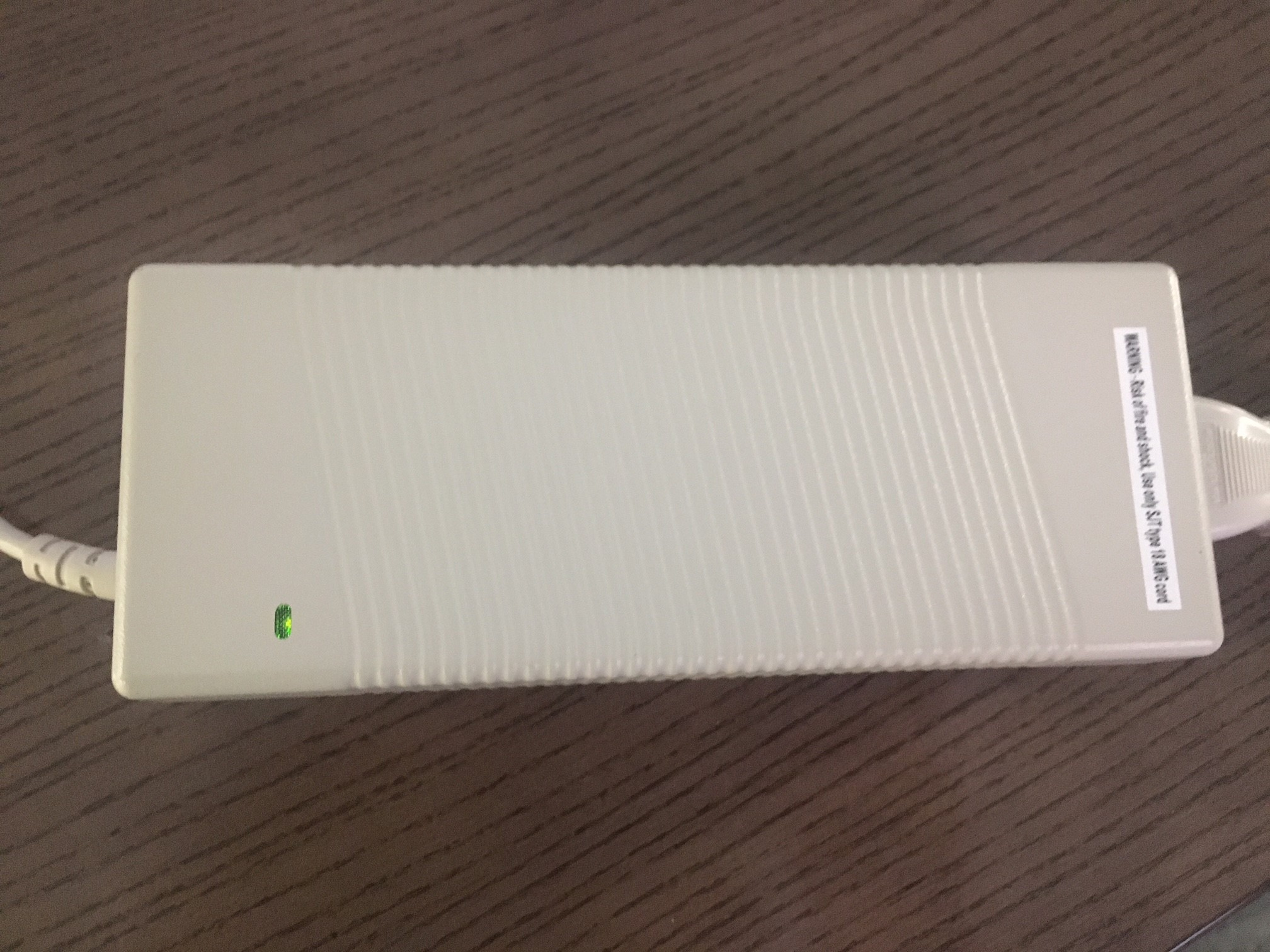 A DualTemp power brick with a green light on.