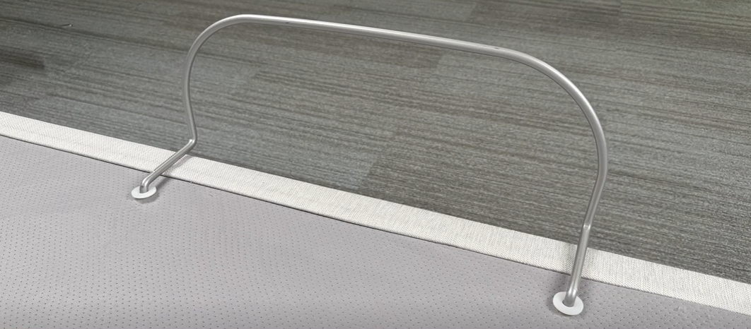 A retainer bar inserted into locater pins that are in the installed into the base.