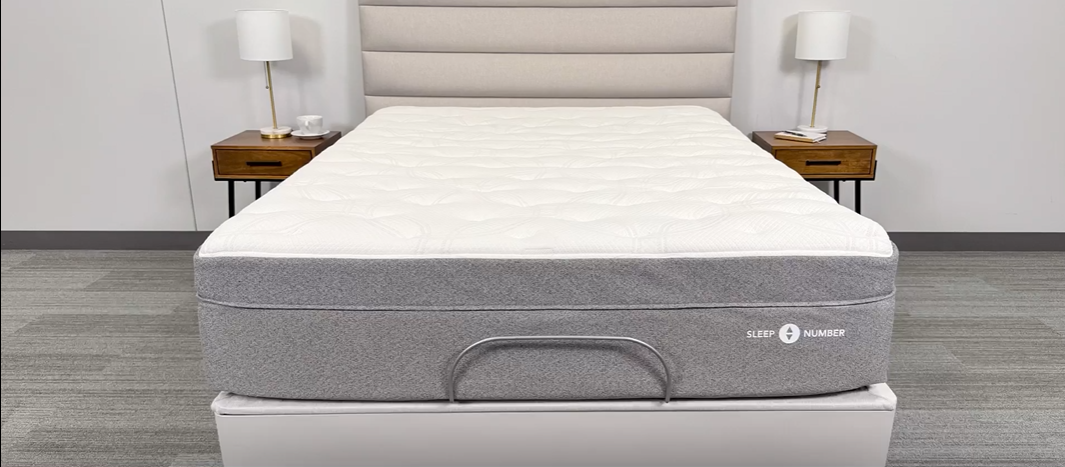 A view from the foot of the bed, showing the retainer bar installed with a mattress on the base.