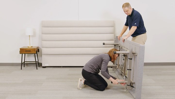 With one person stabilizing the base, insert each leg into the frame receiver.