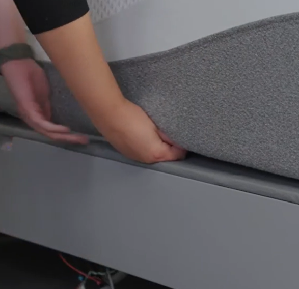 The zipper is located on the bottom of the mattress, typically starting at the head of the bed.
