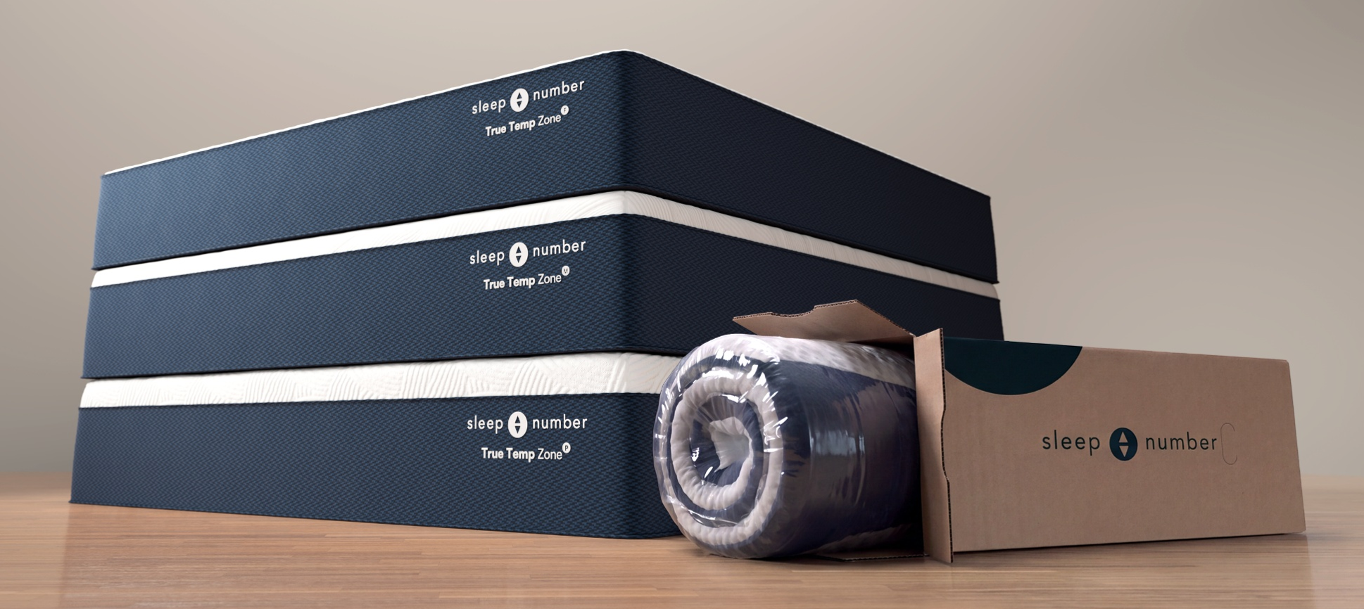Three fully expanded Sleep Number® True Temp Zone™ mattresses in Plush, Medium and Firm comfort levels shown alongside a compressed mattress in a shipping box.